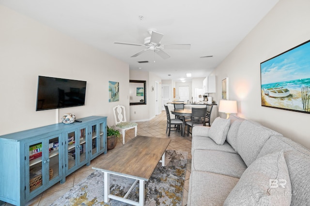 living room featuring light tile patterned floors, ceiling fan, and visible vents