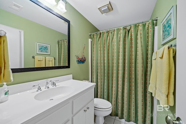 bathroom featuring vanity, tile patterned flooring, and toilet