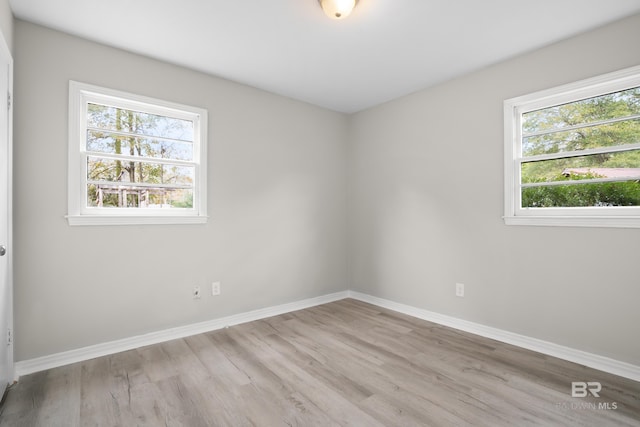 empty room with light hardwood / wood-style flooring