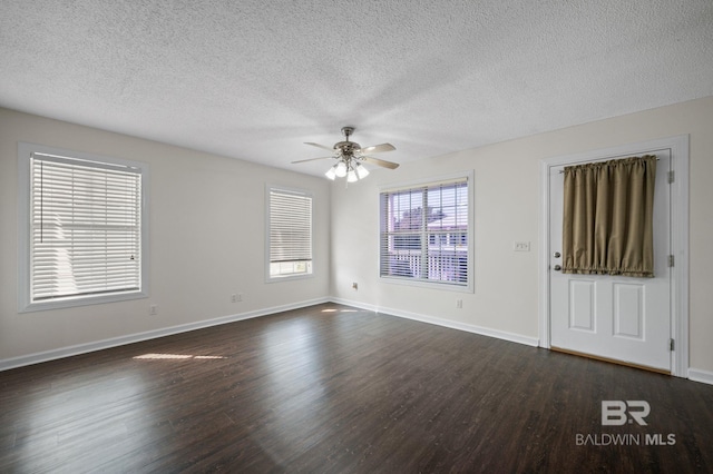 5584 Pensacola Ave, Orange Beach, AL 36561 - empty room featuring a ceiling fan, a textured ceiling, dark wood finished floors, and baseboards