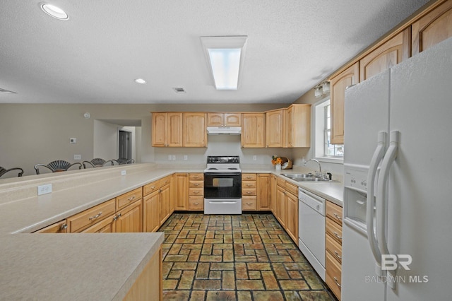 5584 Pensacola Ave, Orange Beach, AL 36561 - kitchen with light brown cabinetry, a sink, brick floor, under cabinet range hood, and white appliances