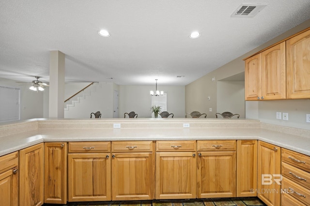 5584 Pensacola Ave, Orange Beach, AL 36561 - kitchen featuring light countertops, ceiling fan with notable chandelier, a peninsula, recessed lighting, and visible vents