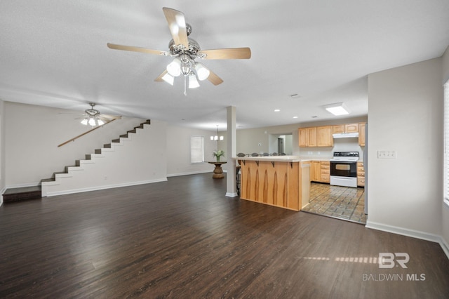 5584 Pensacola Ave, Orange Beach, AL 36561 - kitchen with light countertops, electric stove, open floor plan, light brown cabinets, and under cabinet range hood