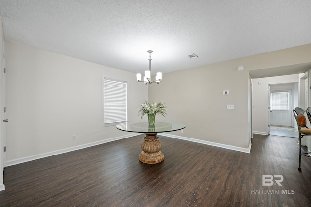 5584 Pensacola Ave, Orange Beach, AL 36561 - dining area with a textured ceiling, visible vents, wood finished floors, baseboards, and a chandelier