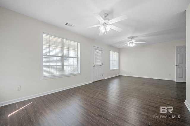 5584 Pensacola Ave, Orange Beach, AL 36561 - unfurnished living room featuring dark wood-style flooring, ceiling fan, visible vents, and baseboards