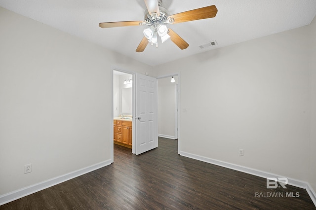 5584 Pensacola Ave, Orange Beach, AL 36561 - unfurnished bedroom featuring baseboards, dark wood-style flooring, and visible vents