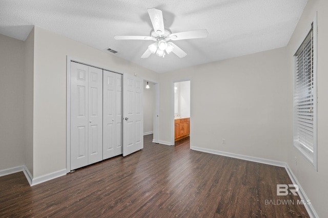 5584 Pensacola Ave, Orange Beach, AL 36561 - unfurnished bedroom with visible vents, a closet, dark wood-style flooring, baseboards, and a textured ceiling