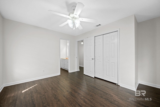 5584 Pensacola Ave, Orange Beach, AL 36561 - unfurnished bedroom with baseboards, dark wood-style flooring, visible vents, and a closet