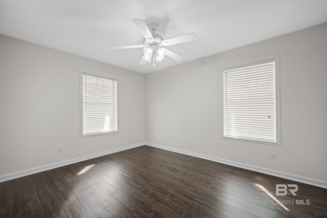 5584 Pensacola Ave, Orange Beach, AL 36561 - empty room with baseboards, a ceiling fan, and dark wood-type flooring