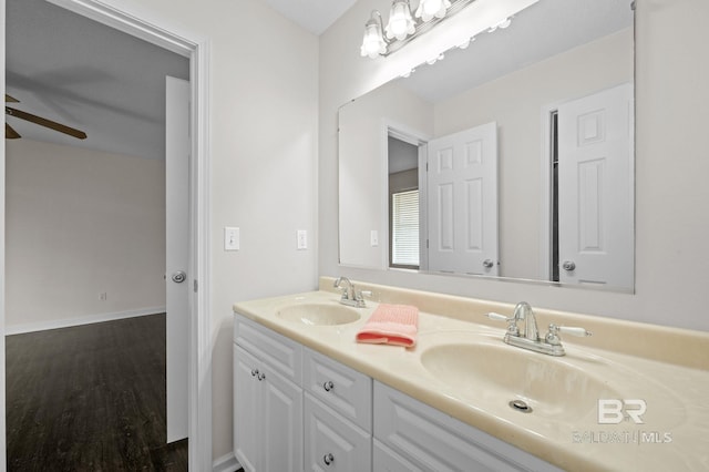 5584 Pensacola Ave, Orange Beach, AL 36561 - bathroom featuring double vanity, a sink, ceiling fan, and wood finished floors