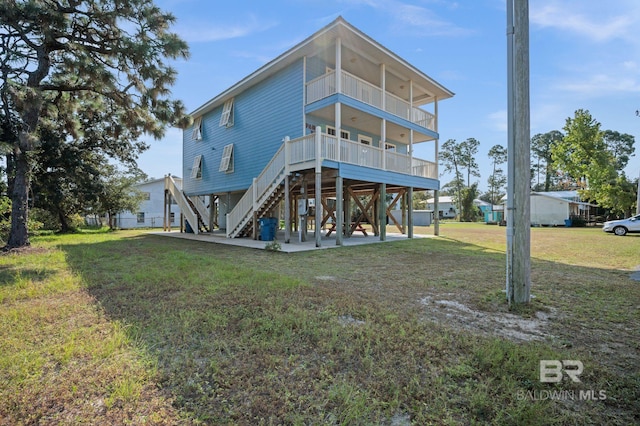 5584 Pensacola Ave, Orange Beach, AL 36561 - rear view of house with stairway and a yard