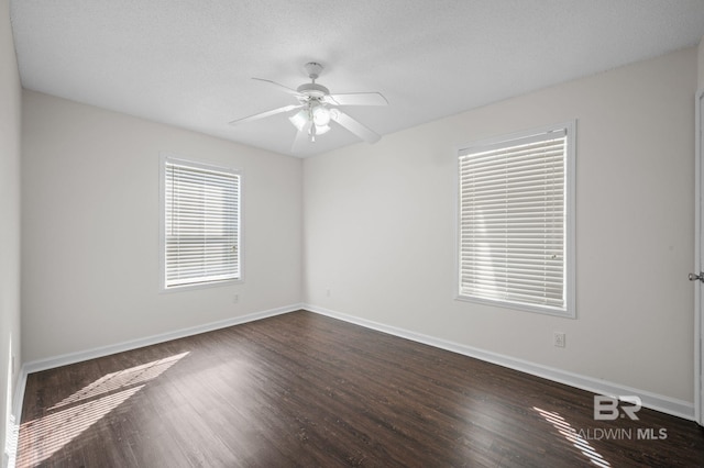 5584 Pensacola Ave, Orange Beach, AL 36561 - empty room with dark wood-style flooring, ceiling fan, and baseboards