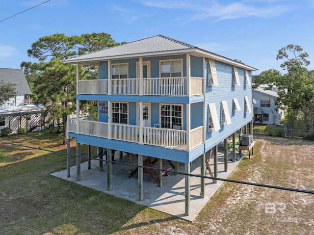 5584 Pensacola Ave, Orange Beach, AL 36561 - back of property with a yard, central AC unit, and a balcony