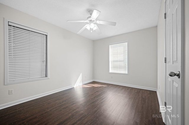 5584 Pensacola Ave, Orange Beach, AL 36561 - spare room featuring dark wood-style flooring, baseboards, ceiling fan, and a textured ceiling