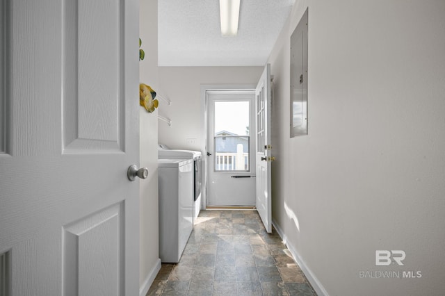 5584 Pensacola Ave, Orange Beach, AL 36561 - laundry area featuring baseboards, washing machine and dryer, stone finish floor, and laundry area