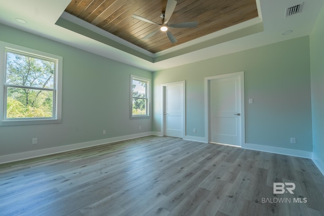 11341 Tall Timber Ln, Elberta, AL 36530 - unfurnished bedroom featuring a raised ceiling, wooden ceiling, multiple windows, and wood finished floors