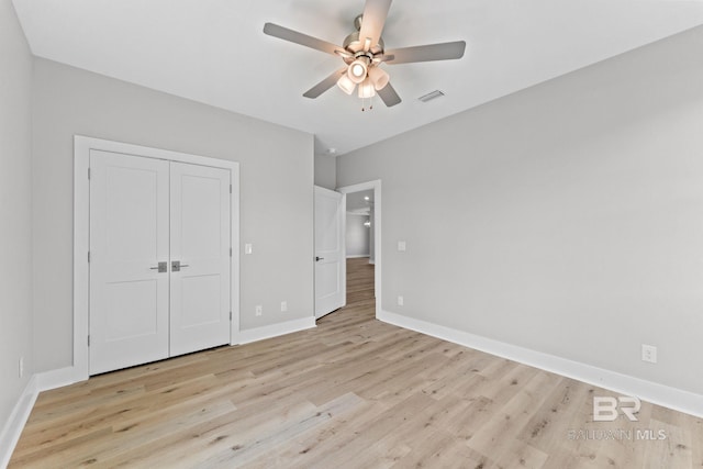 11341 Tall Timber Ln, Elberta, AL 36530 - unfurnished bedroom with light wood finished floors, a closet, and a ceiling fan