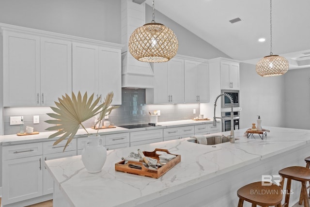 11341 Tall Timber Ln, Elberta, AL 36530 - kitchen with decorative backsplash, white cabinets, a breakfast bar area, high vaulted ceiling, and recessed lighting