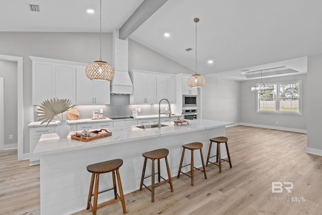 11341 Tall Timber Ln, Elberta, AL 36530 - kitchen featuring oven, built in microwave, decorative backsplash, a large island, and white cabinets
