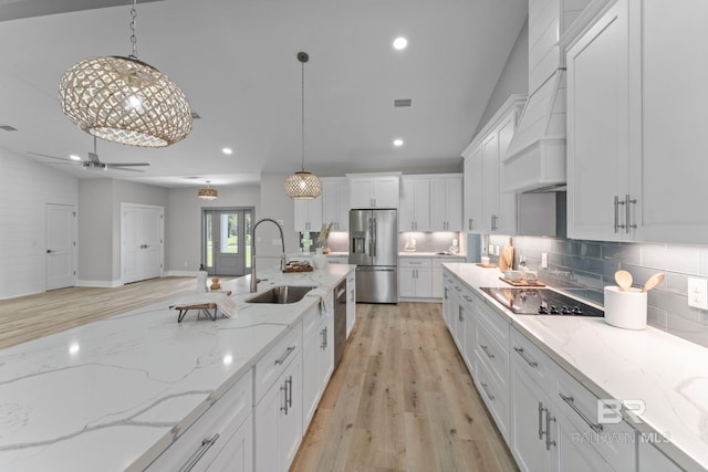 11341 Tall Timber Ln, Elberta, AL 36530 - kitchen featuring stainless steel appliances, white cabinetry, custom exhaust hood, decorative backsplash, and light wood-type flooring