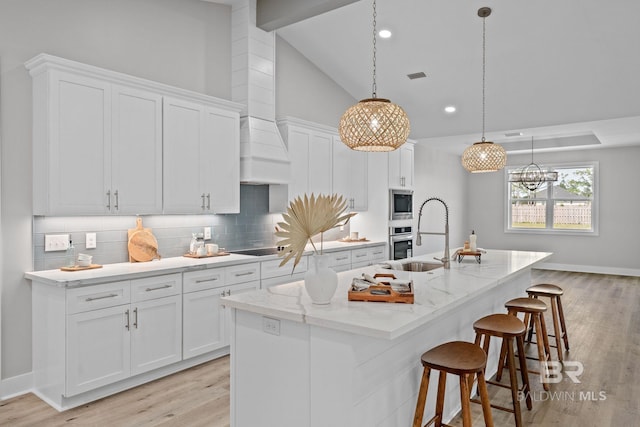 11341 Tall Timber Ln, Elberta, AL 36530 - kitchen featuring appliances with stainless steel finishes, light wood-style flooring, white cabinets, tasteful backsplash, and recessed lighting