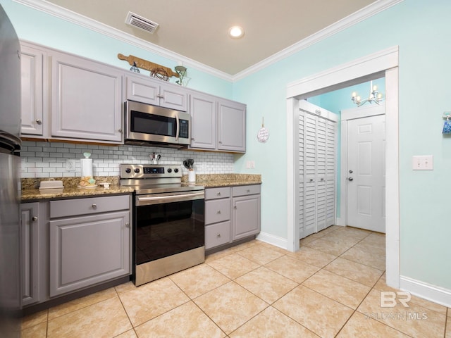 kitchen with gray cabinetry, light tile patterned floors, and appliances with stainless steel finishes