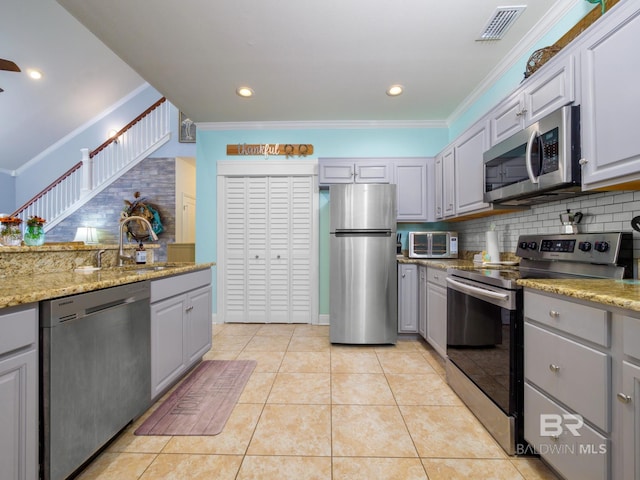 kitchen featuring stainless steel appliances, gray cabinetry, and light tile patterned floors