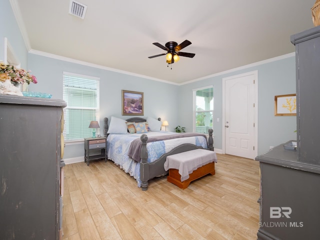 bedroom with ceiling fan, ornamental molding, and light hardwood / wood-style floors