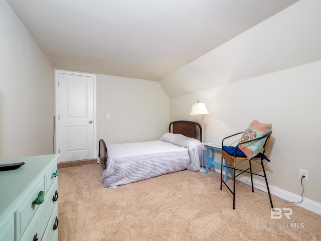 bedroom featuring light carpet and vaulted ceiling