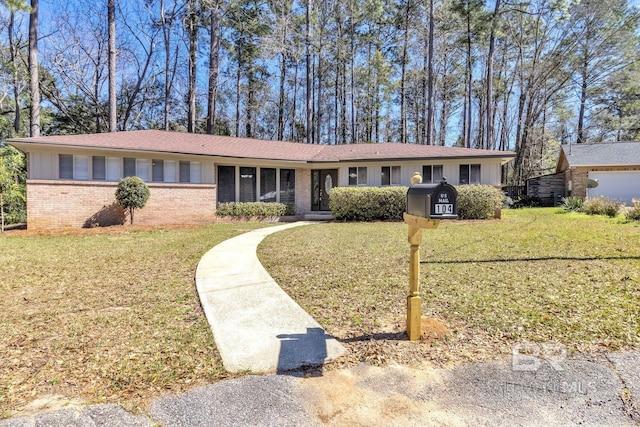 single story home with a front yard and brick siding