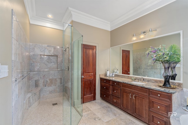 bathroom with tile patterned floors, vanity, a shower with door, and ornamental molding