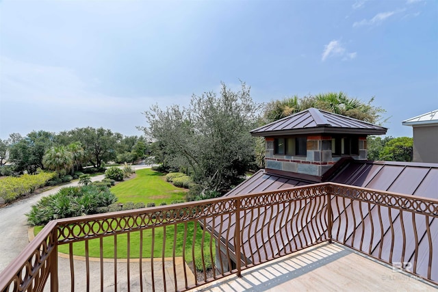 wooden terrace featuring a lawn