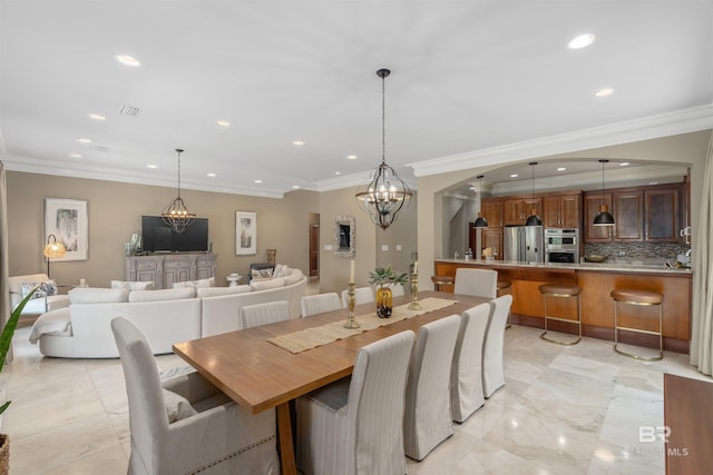 tiled dining room with a notable chandelier and crown molding