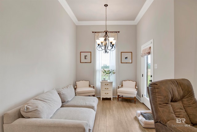 living room featuring crown molding, an inviting chandelier, and light wood-type flooring