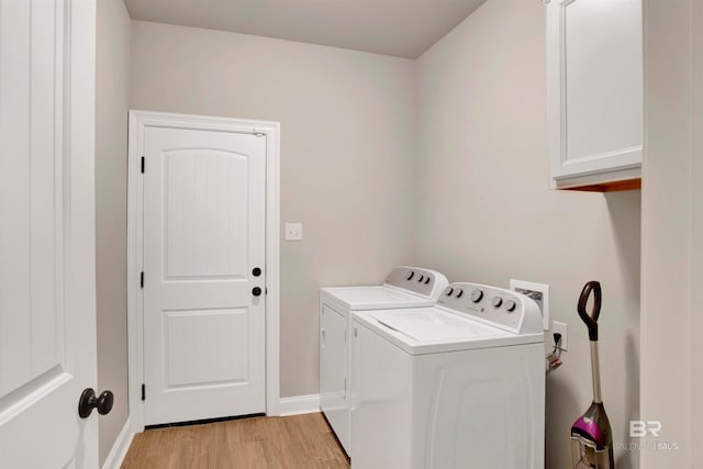 laundry room with cabinets, light hardwood / wood-style flooring, and independent washer and dryer