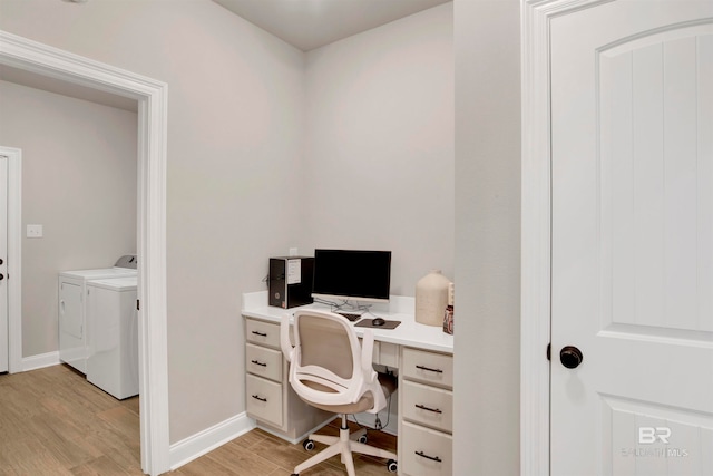 office featuring washing machine and clothes dryer and light hardwood / wood-style floors