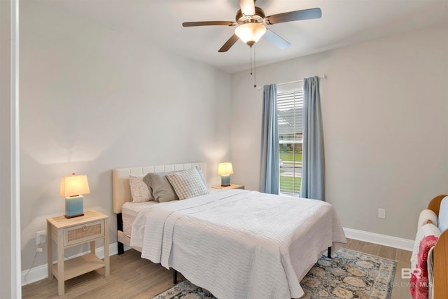 bedroom with light hardwood / wood-style flooring and ceiling fan