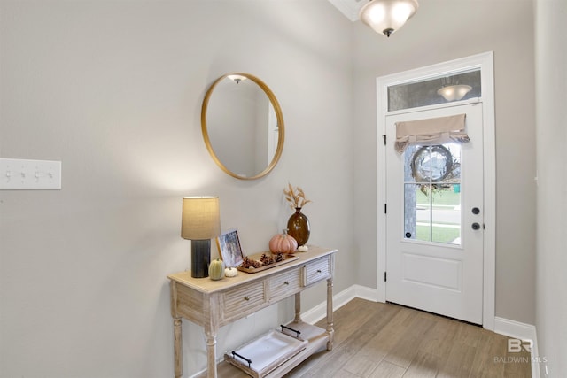 foyer featuring baseboards and light wood-style floors