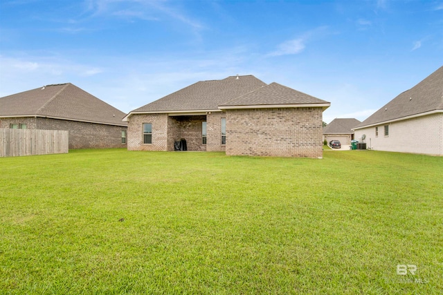 back of property featuring a lawn