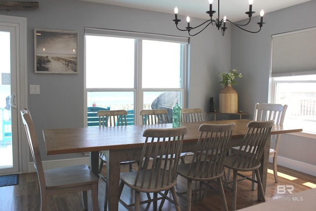 1757 W Beach Blvd, Gulf Shores, AL 36542 - dining space with a chandelier, wood finished floors, and baseboards