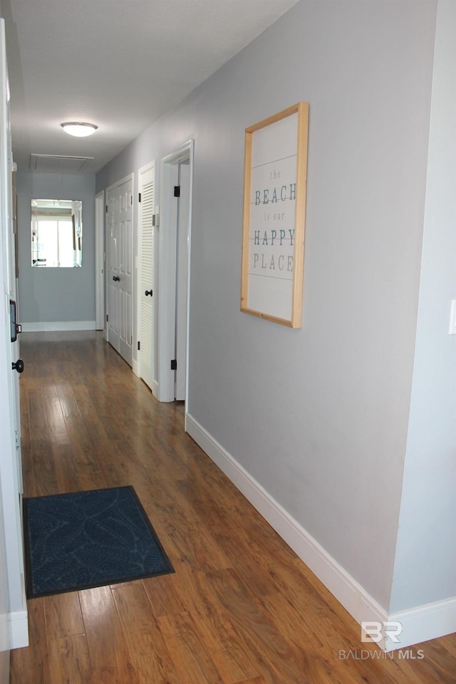 1757 W Beach Blvd, Gulf Shores, AL 36542 - corridor with baseboards, wood finished floors, and attic access
