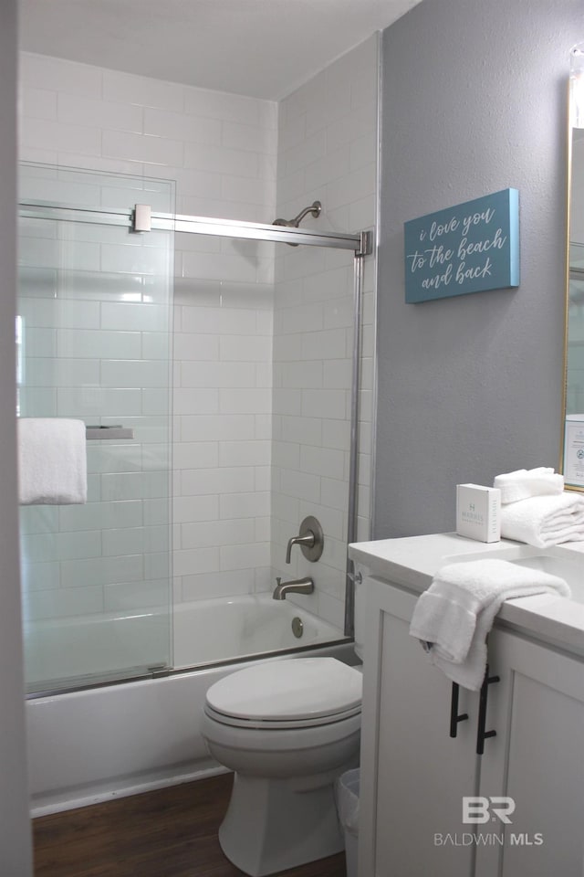 1757 W Beach Blvd, Gulf Shores, AL 36542 - full bath featuring vanity, wood finished floors, bath / shower combo with glass door, and toilet