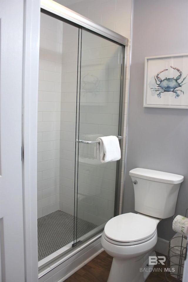 1757 W Beach Blvd, Gulf Shores, AL 36542 - full bathroom with a shower stall, toilet, wood finished floors, and baseboards