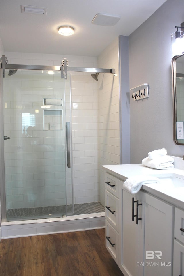 1757 W Beach Blvd, Gulf Shores, AL 36542 - full bath with vanity, a stall shower, and wood finished floors