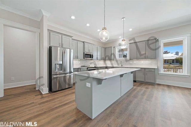 kitchen featuring pendant lighting, tasteful backsplash, dark hardwood / wood-style flooring, and stainless steel appliances