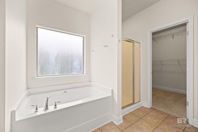 bathroom featuring tile patterned floors and independent shower and bath