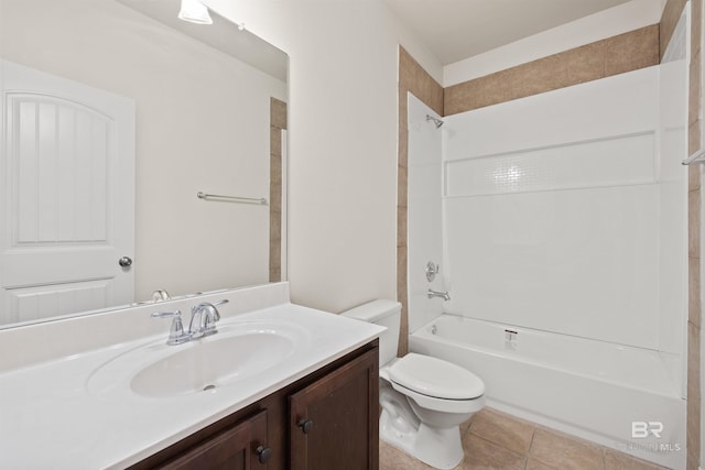 full bathroom featuring vanity, tile patterned flooring, toilet, and tiled shower / bath
