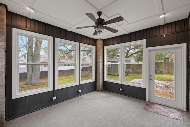 unfurnished sunroom with a wealth of natural light and ceiling fan