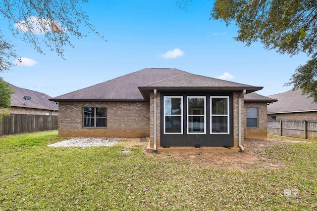 rear view of property featuring a yard