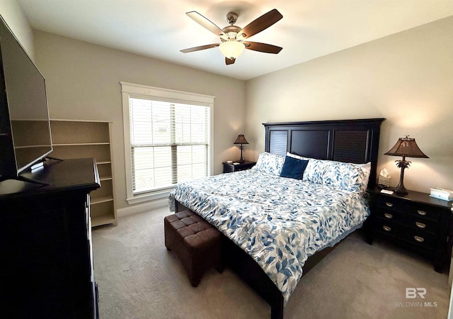bedroom with ceiling fan and light colored carpet